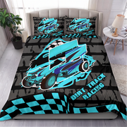A bed dressed in a dirt track racing themed bedding set, featuring a large turquoise and purple race car graphic on a black and gray brick-patterned duvet cover, with two matching pillowcases. The bed is styled in a bedroom setting with a headboard, side table, lamp, and plant.