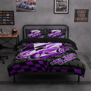 A racing-themed bedding set on a bed in a styled bedroom. The set includes a duvet cover and two pillowcases featuring a purple and white dirt track race car over a black and purple checkered pattern, with the text 'Dirt Track Racing'.