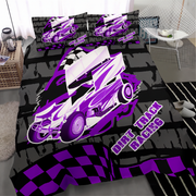 A bedding set featuring a vibrant purple and white dirt track racing car graphic on a black and gray background, shown on a bed in a modern bedroom setting.