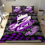 A bed dressed in a custom-printed duvet cover and matching pillowcases featuring a purple and white dirt track racing car design over a black and gray brick pattern, with 'DIRT TRACK RACING' text and a checkered border.
