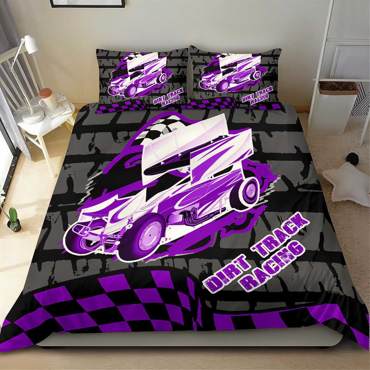 A bed dressed in a custom-printed duvet cover and matching pillowcases featuring a purple and white dirt track racing car design over a black and gray brick pattern, with 'DIRT TRACK RACING' text and a checkered border.