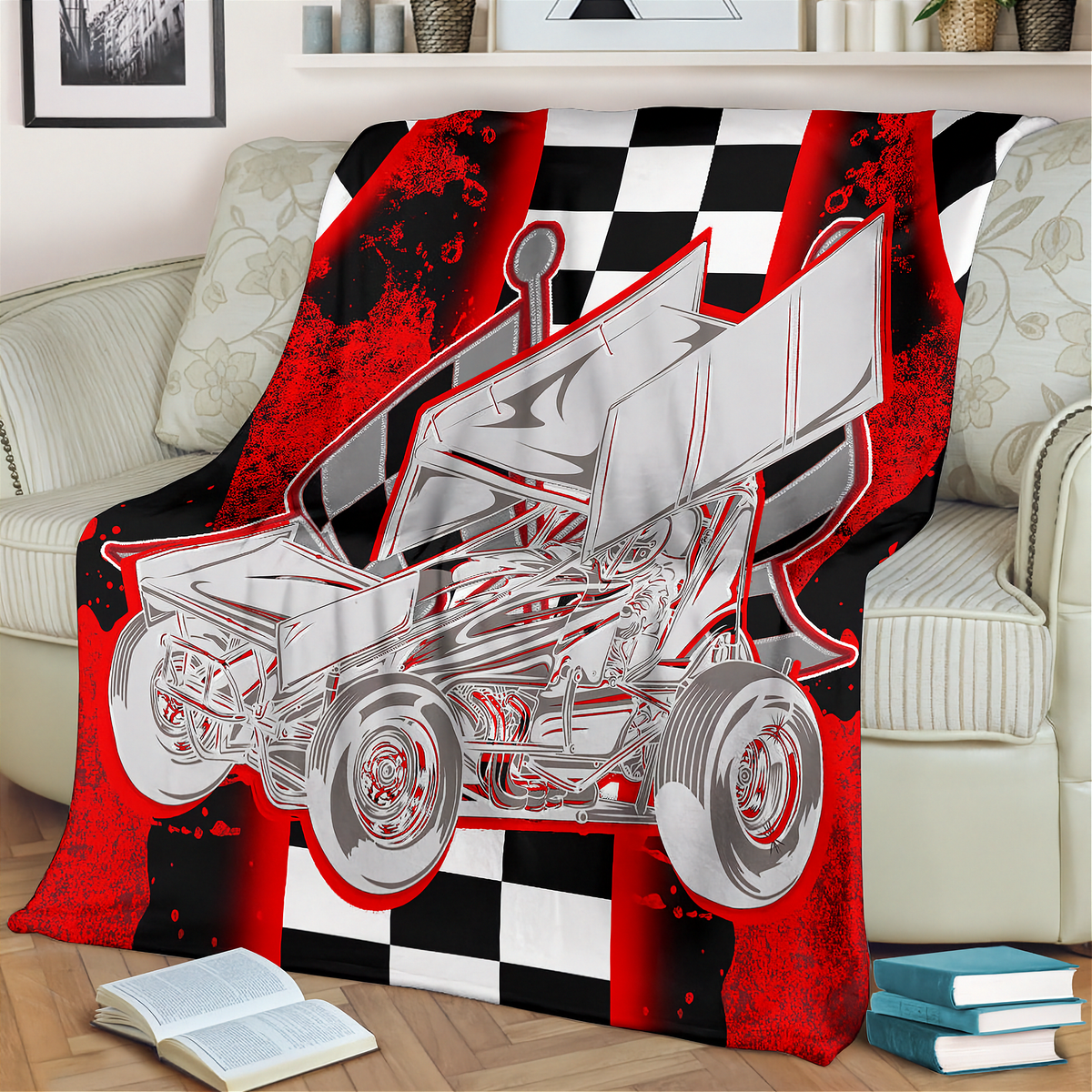 A red and black checkered blanket with a silver sprint car graphic is draped over a beige sofa in a living room setting.