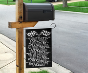 A black metal hanging sign with white racing-themed text and checkered flags, mounted on a wooden post next to a mailbox on a suburban sidewalk.