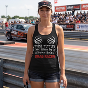 A sassy and fun apparel design featuring the phrase "These Titties Are Taken By A Super Sexy Drag Racer" printed on premium women's t, crop tops, and hoodies.n top