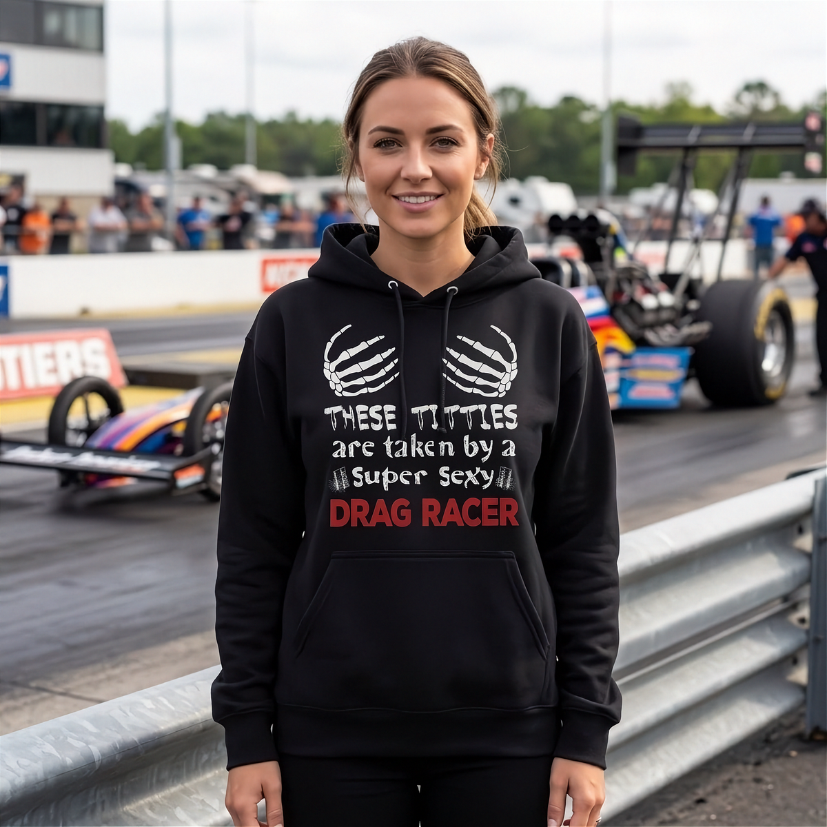 A sassy and fun apparel design featuring the phrase "These Titties Are Taken By A Super Sexy Drag Racer" printed on premium women's hoodie, crop tops, and hoodies.