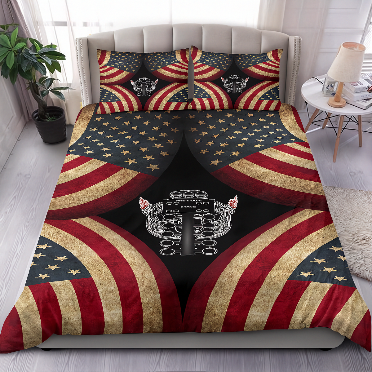 A bed dressed with a patriotic-themed bedding set featuring a distressed American flag pattern and a central metallic engine graphic, shown in a styled bedroom setting.
