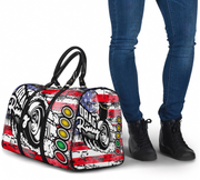 Duffle bag with racing design and person wearing jeans and black shoes