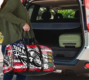Person holding a colorful duffel bag with a car's open trunk in the background