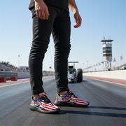 man wearing a usa flag drag racing shoes with a racing background