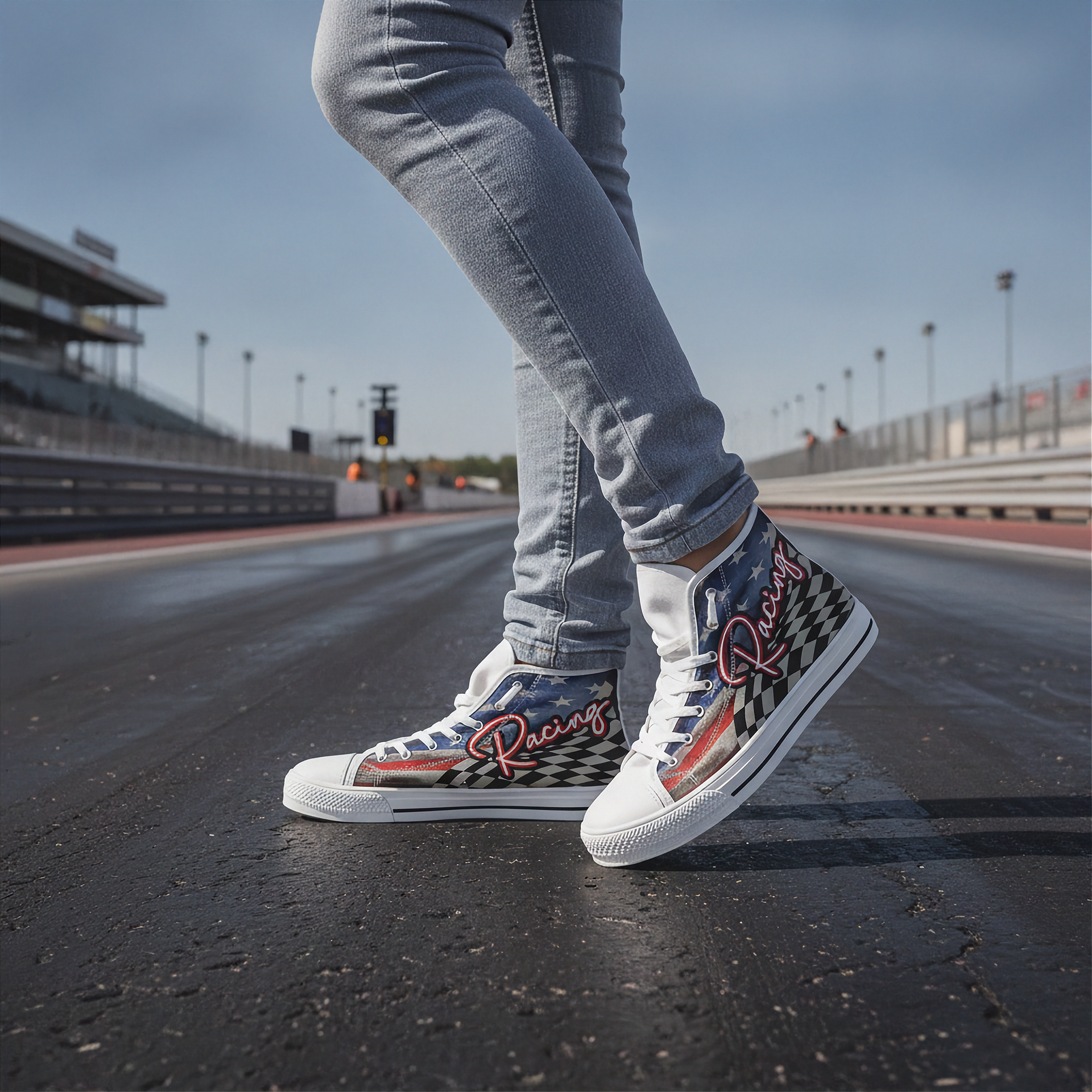 Person wearing white racing high top shoes on a racetrack