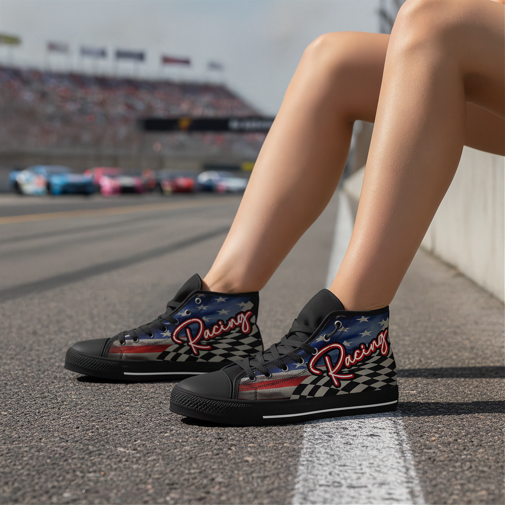 Woman wearing black high-top sneakers with racing design on a race track.