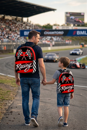 An adult man and an 8 to 12 year old child walking together along a professional race track pit lane, both wearing matching custom red racing track backpacks viewed from behind.