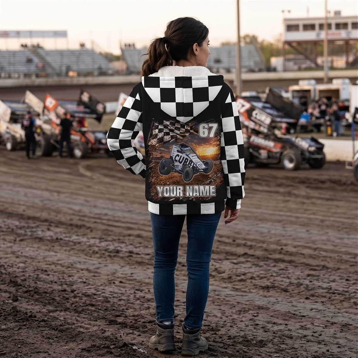 Woman at a dirt track showing the personalized non-wing sprint car artwork on her checkered sherpa jacket.