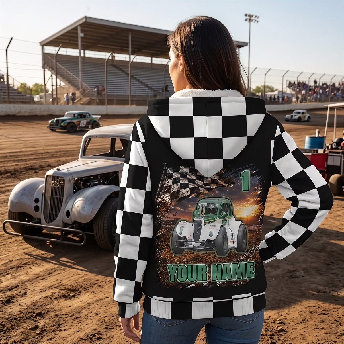 Woman beside a Legends car wearing a custom sherpa jacket, showing number 1, “YOUR NAME,” and checkered