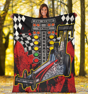 Woman holding a personalized dragster blanket outdoors, featuring a red-and-black background, dragster photo and Christmas tree starting lights.