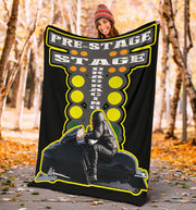 Woman in a knit hat holding the snowmobile asphalt blanket on an autumn path, displaying the full starting-tree and rider design.