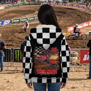 Woman watching motocross in a personalized dirt bike sherpa jacket, with rider artwork, number 96, and “YOUR NAME” on the back.