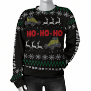 A black crewneck sweater displayed on a headless mannequin, featuring a festive holiday design with red 'HO-HO-HO' text, white snowflakes, green zig-zag patterns, and gray reindeer pulling sleds with yellow and blue ATVs.