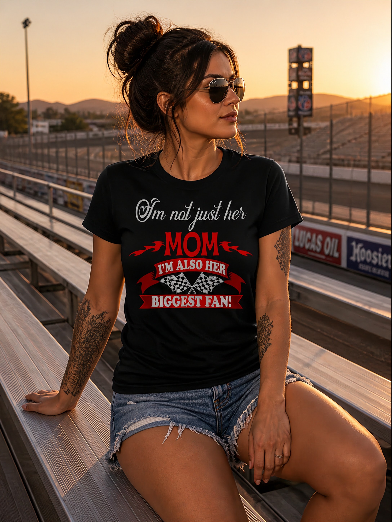 Women's apparel featuring the heart-warming "I'm Not Just Her Mom I'm Also Her Biggest Fan" slogan available in multiple styles including racerback tanks and cozy hoodies.