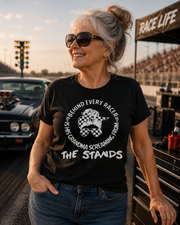 Women's motorsport apparel featuring the bold "Behind Every Racer Is His Grandma Screaming From The Stands" graphic, available in premium t-shirts, tanks, and hoodies.