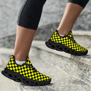 Black and yellow checkered shoes on a person's feet standing on stone steps.