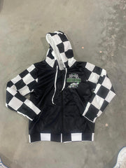 A personalized racing jacket displayed on a mannequin, featuring a large, high-resolution photo of a custom muscle car printed on the back panel, complemented by black and white checkered flag accents on the sleeves and a plush, cream-colored sherpa lining visible at the collar.