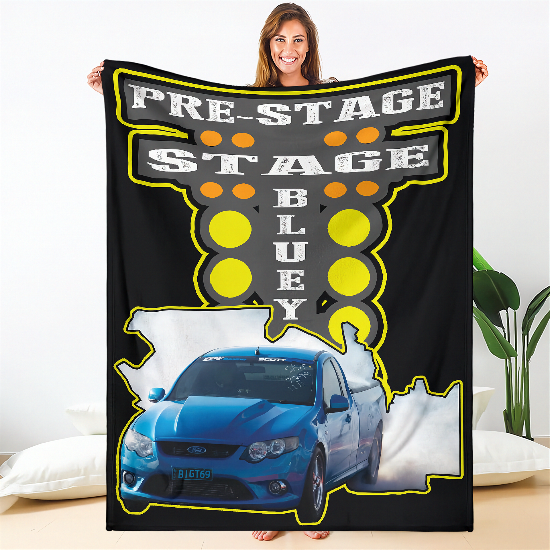 Person holding a drag racing blanket with 'Pre-Stage Stage Bluey' design featuring a blue car.