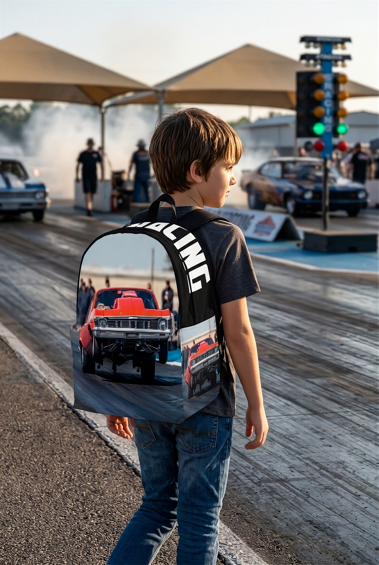 Custom personalized drag racing backpack for kids featuring an orange race car launching at the drag strip for back to school gear.