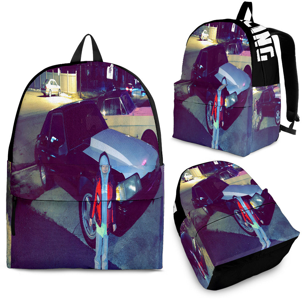 Custom personalized drag racing backpack for kids featuring an orange race car launching at the drag strip for back to school gear.