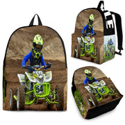 Custom personalized quad ATV backpack for kids featuring an off-road four-wheeler leaping over a muddy jump for back to school gear.