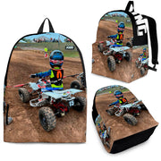 Custom personalized quad ATV backpack for kids featuring an off-road four-wheeler leaping over a muddy jump for back to school gear.