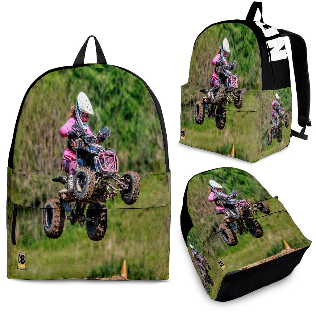 Custom personalized quad ATV backpack for kids featuring an off-road four-wheeler leaping over a muddy jump for back to school gear.