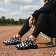 woman sitting at a dirt track wearing a custom checkered shoes