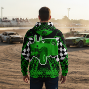 man wearing a green and black demolition derby checkered hoodie with car design at a race track.