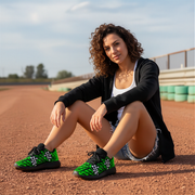 Woman sitting on a track wearing green checkered shoes