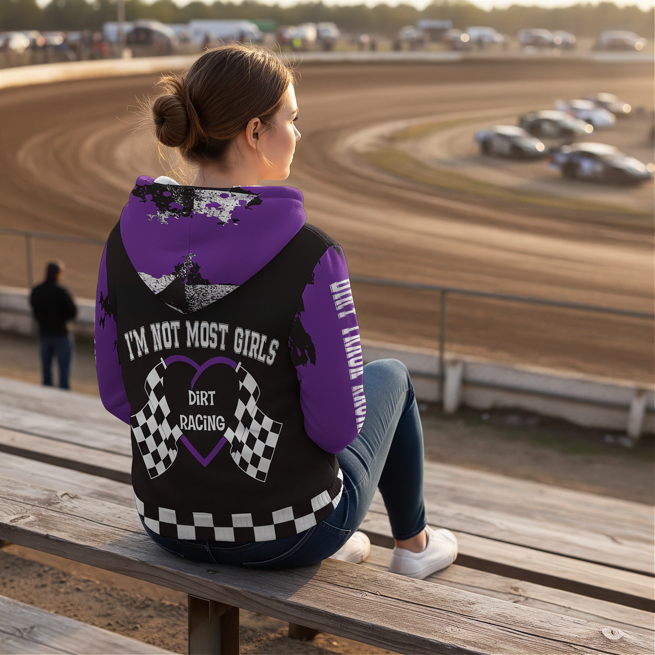 Woman sitting at a dirt race track wearing a dirt racing sherpa hoodie
