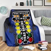 Blanket with drag racing design draped over a couch in a living room.