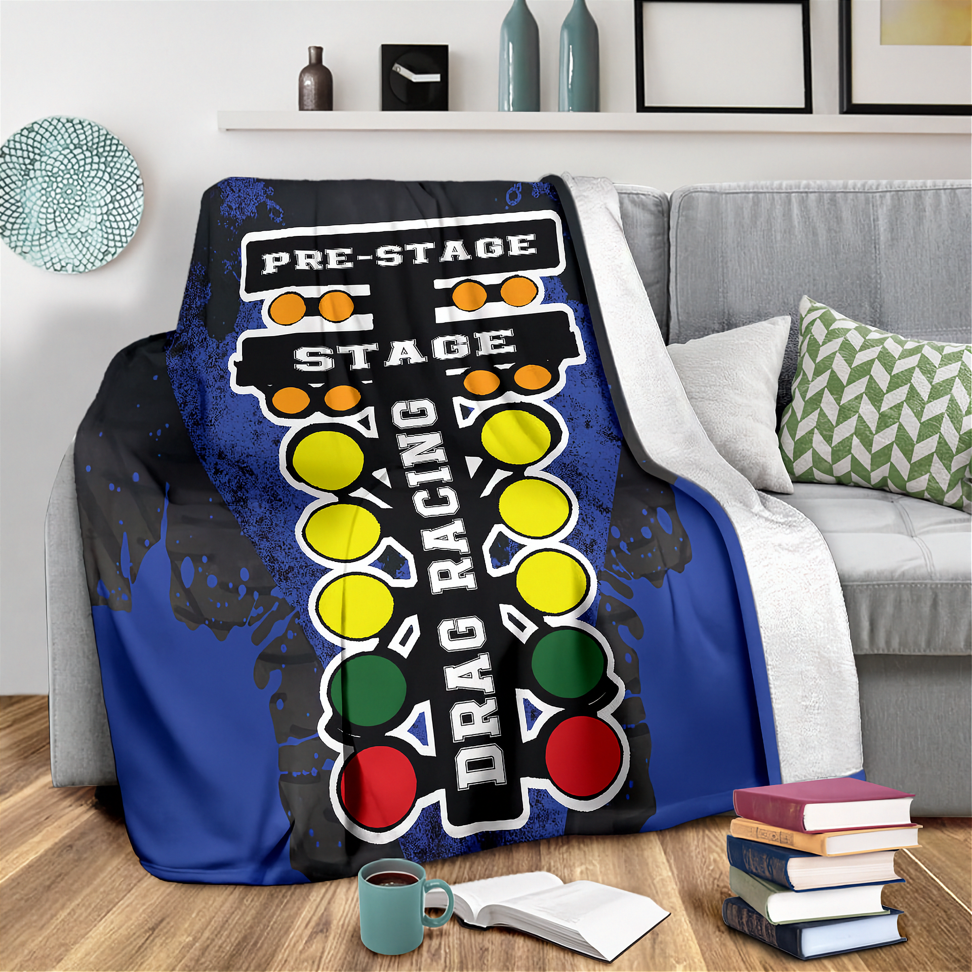 Blanket with drag racing design draped over a couch in a living room.