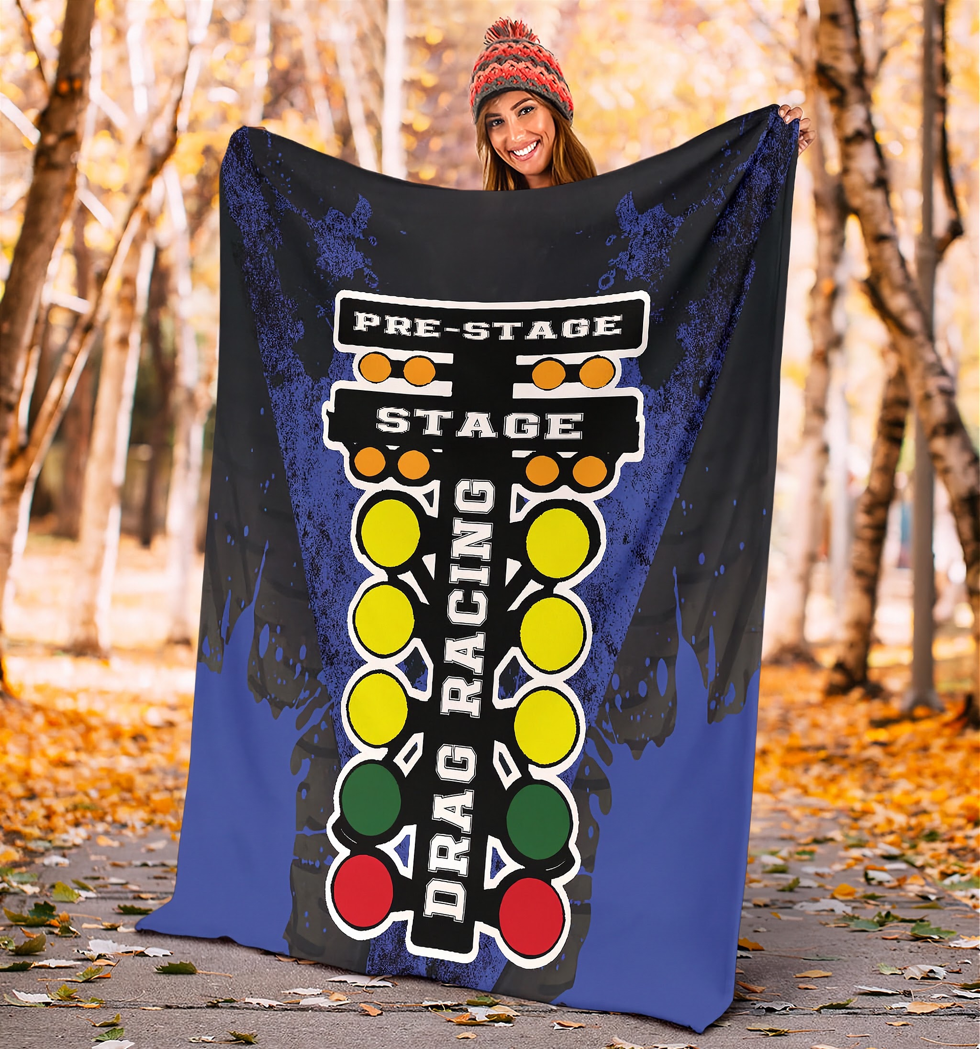 woman in a forest holding a drag racing themed blanket