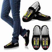 Black slip-on shoes with colorful designs on a white background
