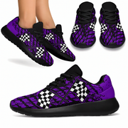 A pair of custom-designed dirt racing sneakers featuring a purple and black muddy tire track pattern with crossed checkered flags, shown from two different angles on a solid white background.