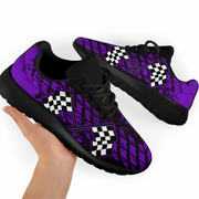 A pair of custom-designed dirt racing sneakers featuring a purple and black muddy tire track pattern with crossed checkered flags, shown from two different angles on a solid white background.