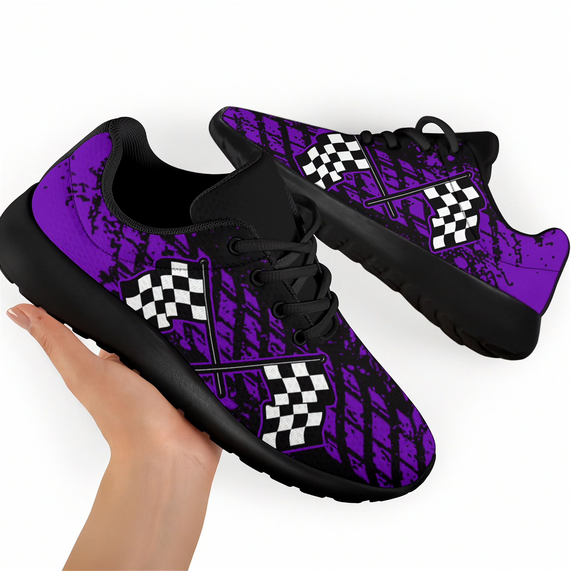 A pair of custom-designed dirt racing sneakers featuring a purple and black muddy tire track pattern with crossed checkered flags, shown from two different angles on a solid white background.