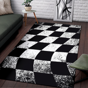 Black and white checkered rug in a living room setting with a sofa and table.