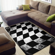 Living room with a checkered black and white rug, brown sectional sofa, and green cushions.