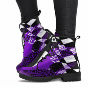 Purple and black patterned boots worn with black jeans on a white background