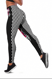Black and white checkered leggings with pink accents worn by a person on a white background
