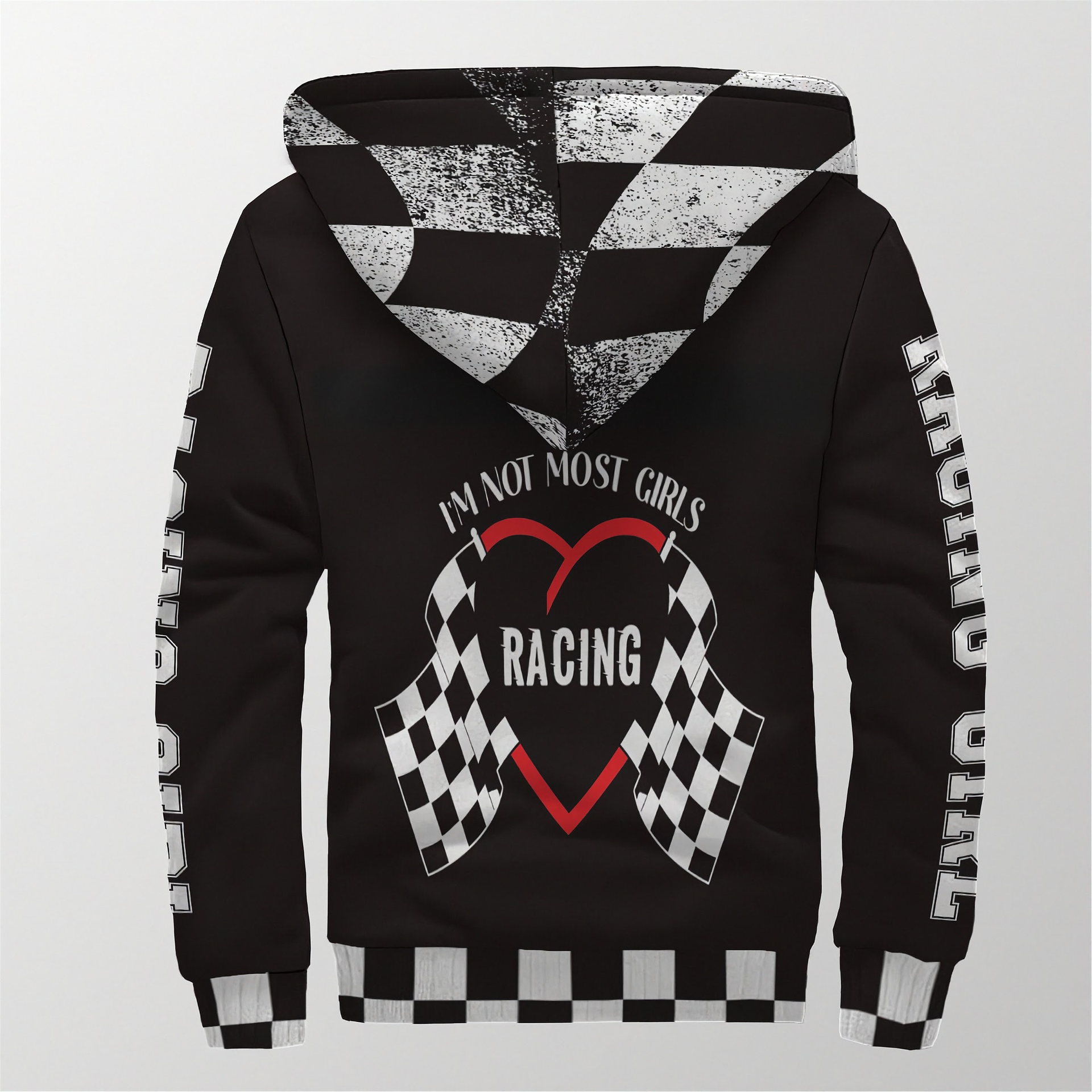 A stylish female race fan wearing the black "I'm Not Most Girls" sherpa jacket, with the hood up, standing under the bright LED lights of a racetrack grandstand, focusing on the textured lining and bold print.