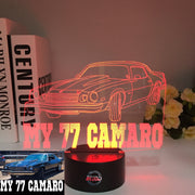 1977 Chevy Camaro 3D LED Illusion Lamp showing the classic second-generation silhouette in a vibrant yellow glow on a premium black base.