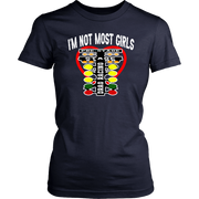 A bold and stylish apparel design featuring the text "I'm Not Most Girls" with drag racing graphics, printed on premium women's t-shirts, tanks, and hoodies.